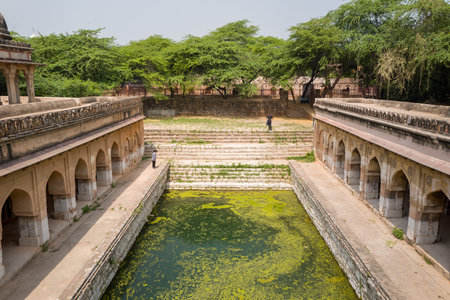 Delhi, India - March 30, 2024: The image shows the Rajon Ki Baoli stepwell at the Mehrauli...