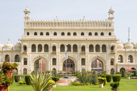 Lucknow, India - March 16, 2024: The image shows the main entrance facade of Bara Imambara, a historic Mughal-style monument, with a landscaped garden and potted plants in the foreground under daylight.のeditorial素材