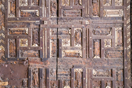 Bundi, India - March 20, 2022: Close-up view of a historic wooden door at Garh Palace featuring geometric inlay patterns with ivory and metal elements.のeditorial素材