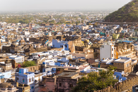 Bundi, India - March 20, 2022: An elevated view shows the densely built old town area with historic stone buildings, blue-painted houses, domes, and narrow streets under daylight.のeditorial素材
