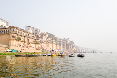 Varanasi, India - March 19, 2024: Several wooden boats are moored along the steps of Darbhanga Ghat...