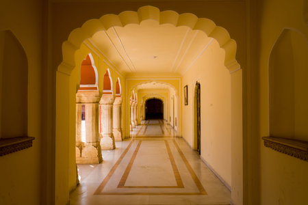 Jaipur, India - March 16, 2022: An arched corridor inside City Palace at Pritam Chowk is shown with...