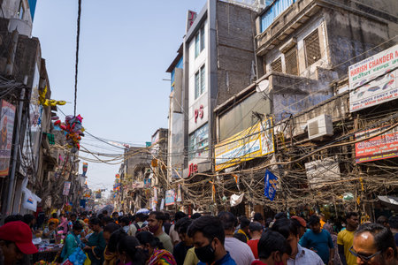 Delhi, India - March 13, 2022: A crowded street scene in Sadar Bazaar shows numerous pedestrians,...