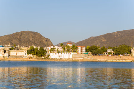 Pushkar, India - March 17, 2022: Pushkar Lake is visible in the foreground with several ghats,...