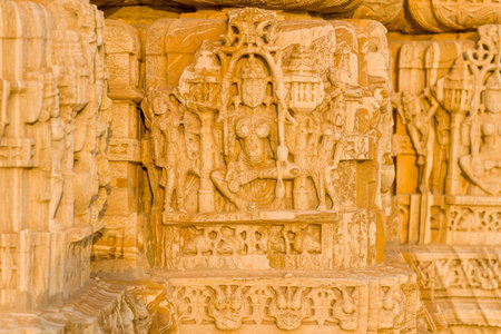Chittorgarh, India - March 21, 2022: The image shows intricate stone carvings depicting deities and human figures on the exterior wall of the Jain Shvetambar Temple, with ornate reliefs and detailed architectural elements visible.のeditorial素材