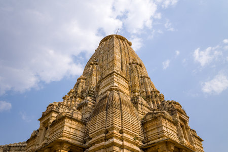 Chittorgarh, India - March 21, 2022: The image shows an upward perspective of the detailed stone shikhara of Kumbhshyam Temple against a partly cloudy sky.のeditorial素材