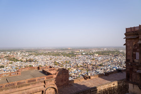 Jodhpur, India - March 25, 2022: The image shows a wide panoramic view of the city of Jodhpur as seen from the ramparts of Mehrangarh Fort, with densely packed buildings and a clear sky in the background.のeditorial素材