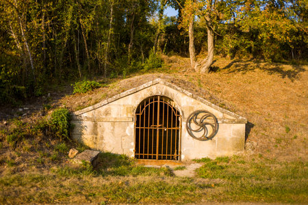 Cuncy les Varzy, France - September 13, 2020: The image shows a small stone spring house built into...
