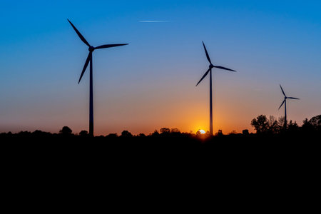 Wind turbines at sunsetの写真素材