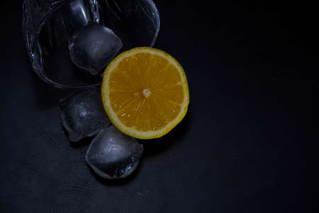glass with ice cubes and lemonの写真素材
