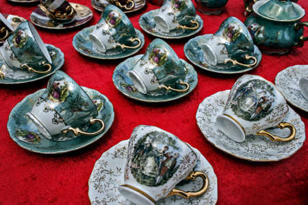 Old ceramic cups with paintings and gold applied のeditorial素材