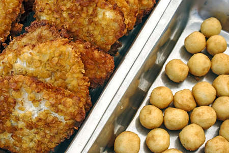 Schnitzel and potatoes on plates exposed for consumptionの写真素材