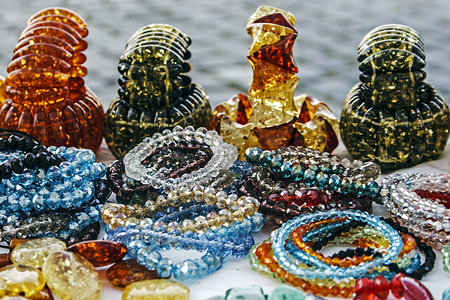 Different colored bracelets and trinkets displayed in the waiting customers のeditorial素材