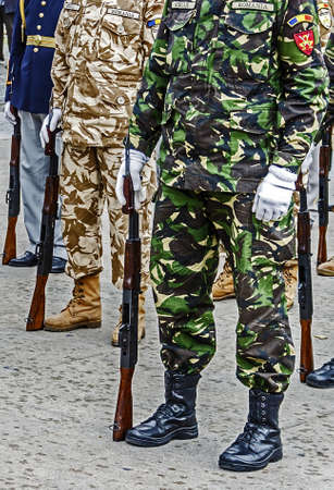 Platoon of soldiers in formation, performing movements with weapons at a military demonstration on the Army Day の写真素材