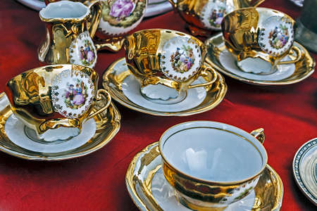 Old ceramic cups with gold applied and paintings の写真素材
