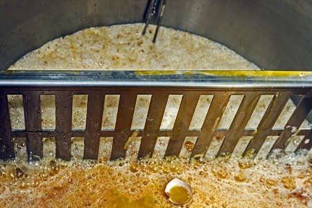 Melange consisting of egg white and egg yolk, put together in a container and coming from a industrial machines for broken eggs  After packing, product is used in bakeries and pastry の写真素材