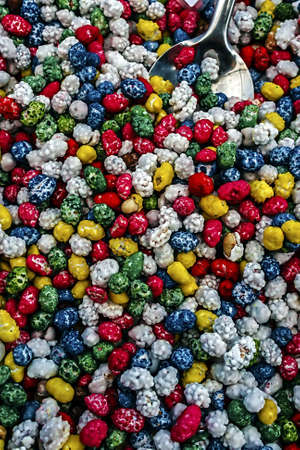 Colorful peanuts in bulk for sale, at a fair with sweets の写真素材