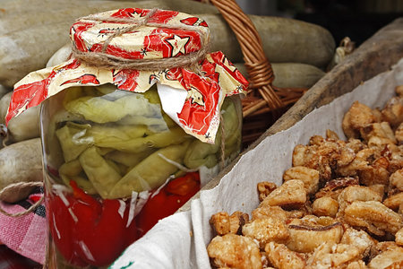 Traditional pickles, cracklings and sausages, placed on a table の写真素材