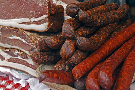 Pieces of smoked pork bacon overlapping, together with sausages Traditional Romanian food, shall specify in the month of December の写真素材