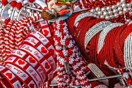 Bracelets with love logos, beads and necklaces in white and red, displayed on a stand  Symbolizes the arrival of spring の写真素材