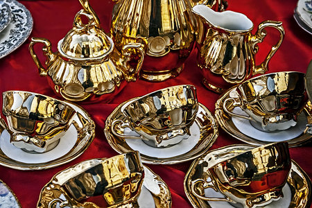 Old ceramic cups with gold applied and paintings 