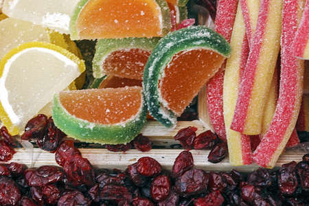 Colorful jelly in fruit slices shaped together with colored jelly strap shaped and raisins  Displayed in boxes for sale  Homemade sweets の写真素材