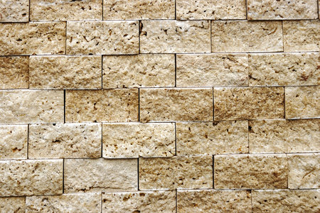 Decorative wall from ornamental stones, on brown and white colors 