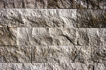 Decorative wall from ornamental stones, on brown and white colors 