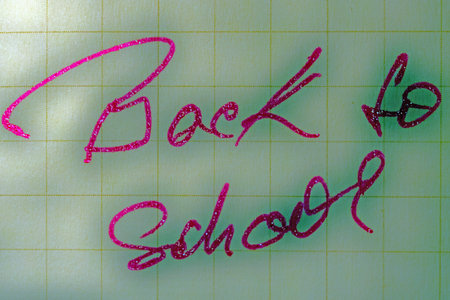 Inscription color slogan ,, Back to school   in a cheerful color pink with stars 
