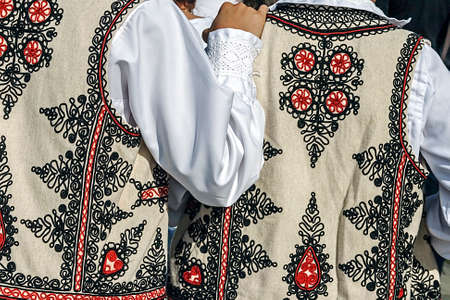Friendship between two people who wears traditional costumes Romanian specific area Banat, Romania の写真素材