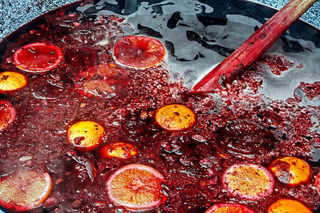 Red wine with orange and lemon pieces, boil in a large bowl and mix with a wooden spoon  Romanian...