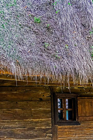 Old Romanian house with thatched roof, specific to Banat area.の写真素材