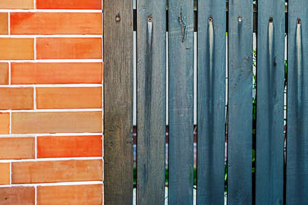 Fence plated with ornamental stone and planks.の写真素材