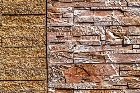 Decorative wall from ornamental stones, on brown and white colors.の写真素材