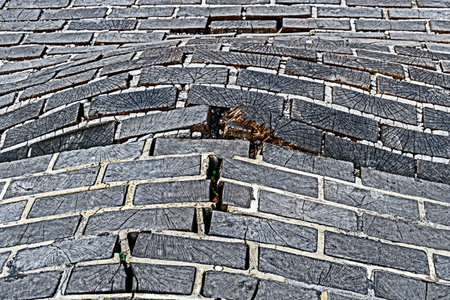 Paving from wooden square, bloated and damaged.