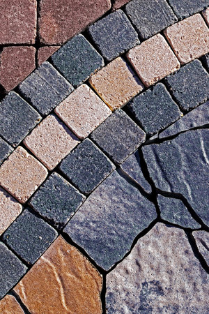 Detail of cobblestone sidewalk made of cubic stones.