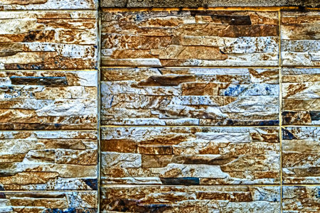 Decorative wall from ornamental stones on various colors.