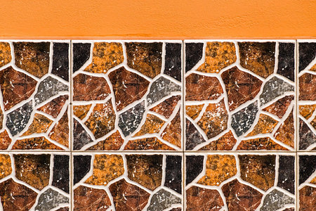Decorative wall facade with a plaster part painted and in the bottom part with tiles.