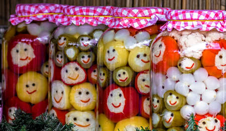 Various types of pickles which symbolizes happy faces, prepared in large jars. Specific to the area Maramures, Romania.の写真素材