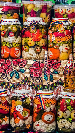 Various types of pickles which symbolizes happy faces, prepared in large jars. Specific to the area Maramures, Romania.の写真素材