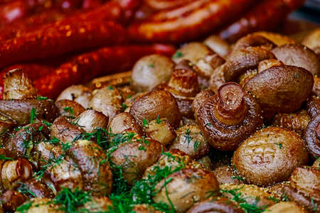 Mushrooms and fried sausages, ready to be served.の写真素材