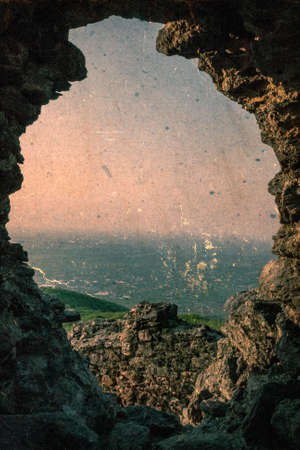 Old photo with ruins fortress Siria located in district Arad, Romania. Image digitally manipulated in the form of old photos.の写真素材