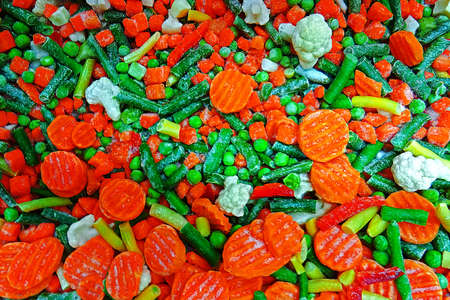 Pieces of frozen vegetables, cut into small pieces.の写真素材