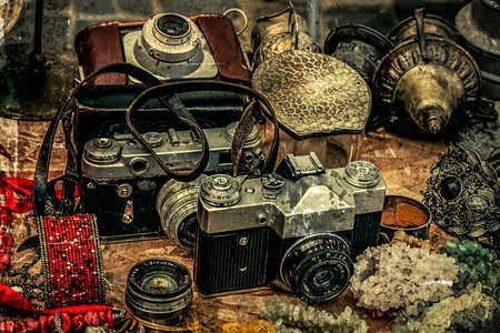 Old postcards with vintage look at one fair. Old photo cameras and different antiques.