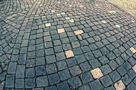 Vintage look at cobblestone sidewalk made of old cubic stones.の写真素材