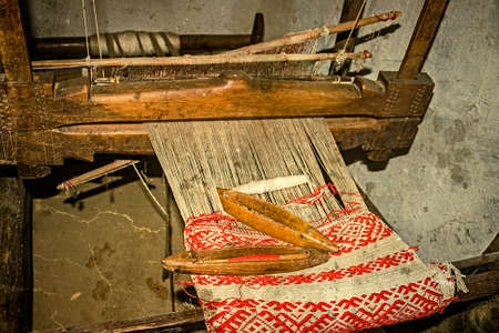 Romanian farmhouse interior,with loom detail. The Banat region (part of Transylvania), Romania. Image digitally manipulated in the form of old photos.の写真素材