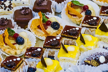 Various sweets with cream, chocolate and fruits.