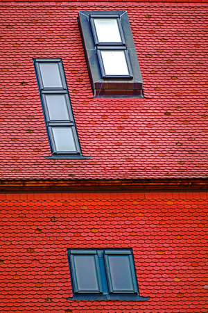 Roof with new tiles and different types of windows.