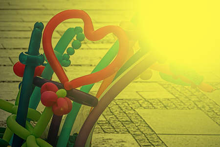 Colorful balloons, in different shapes knotted, exposed on the street in the morning light.の写真素材