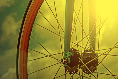 Vintage look at one bicycle detail on a background of sky, in the morning light.の写真素材